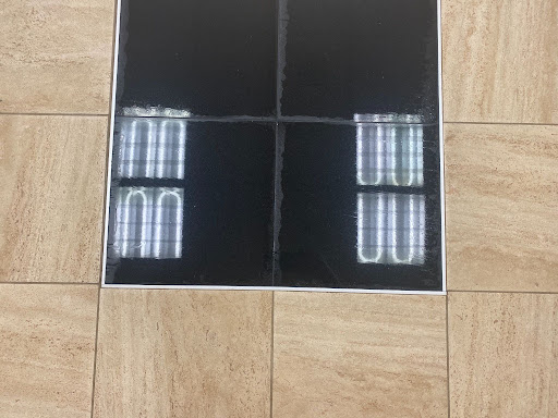 Dirty grout lines beside cleaned grout after treatment.